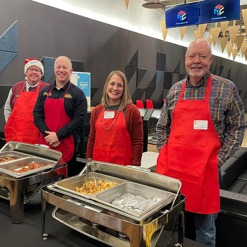 KCSL Volunteers standing in front of the breakfast buffet